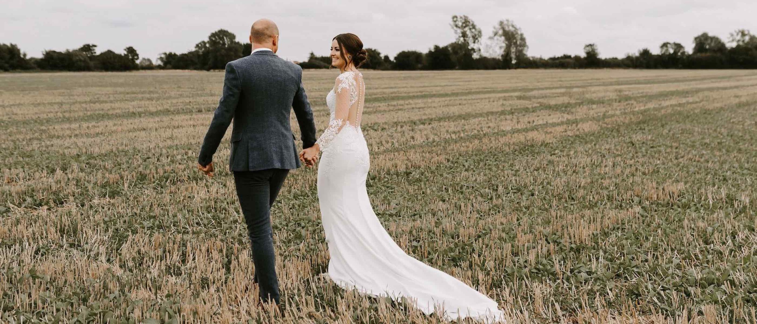 Сouple wearing a white gown and a black suit