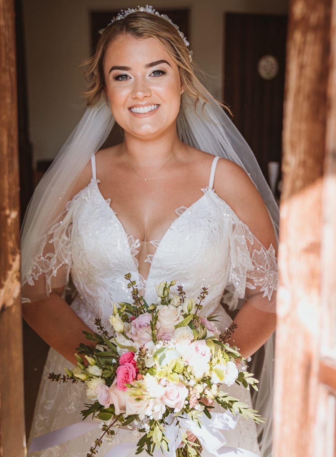 Model wearing a white gown with a flowers